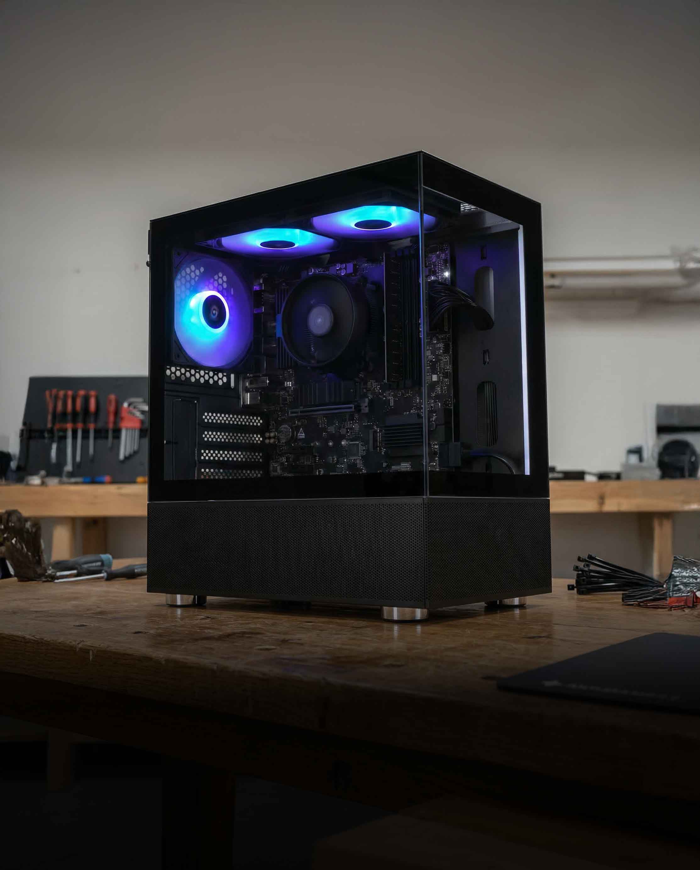 Computer case with glowing blue lights on a wooden desk